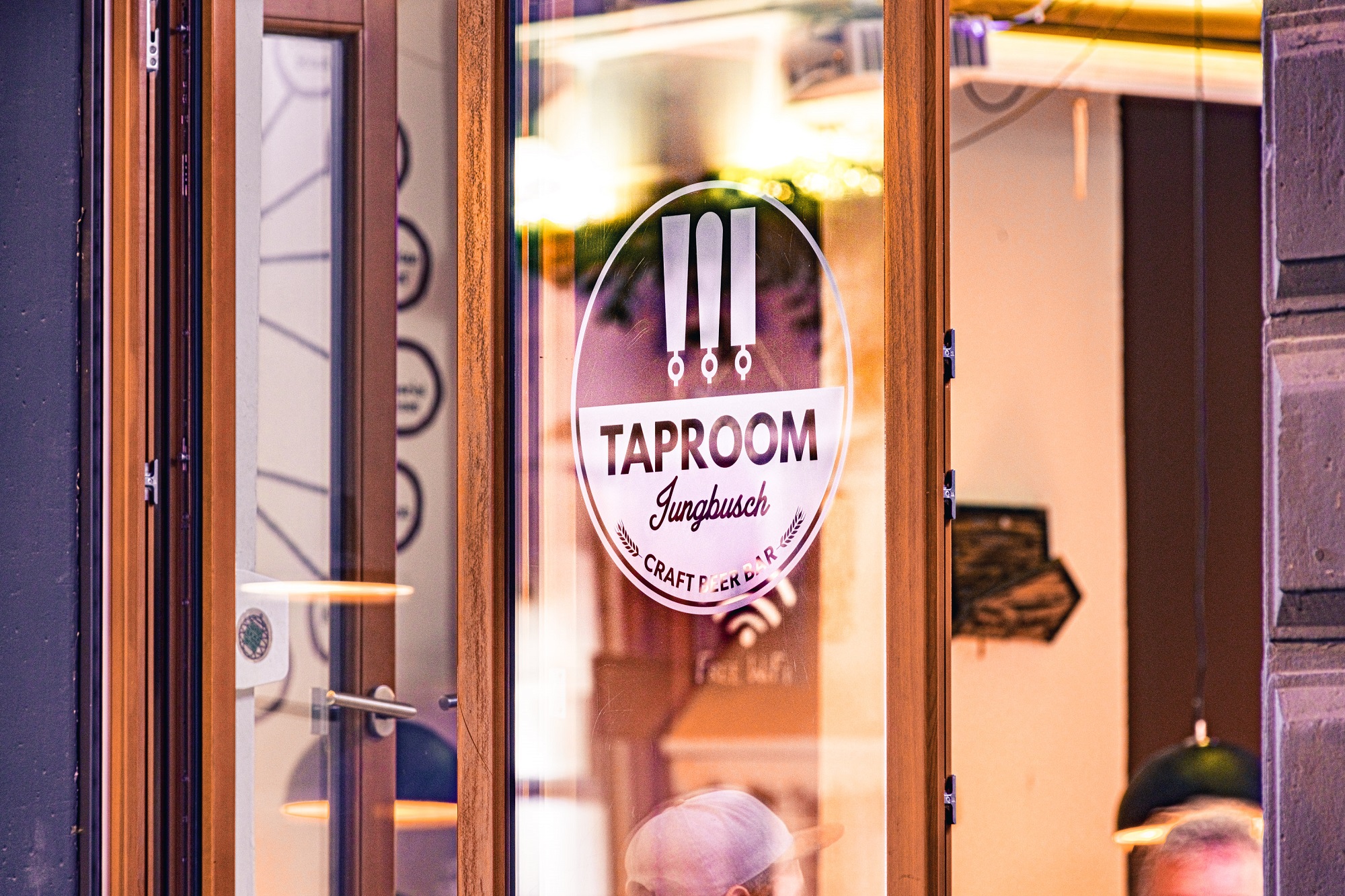 Exterior view of taproom logo in shop window